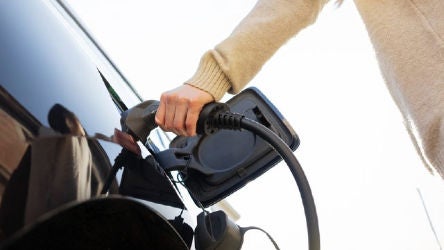 Person charging their electric vehicle